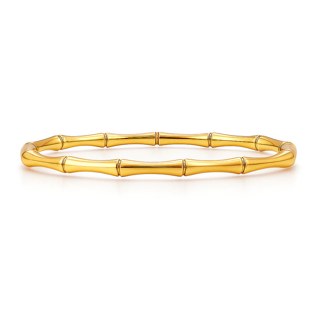 Gold bracelet with bamboo design on a white background