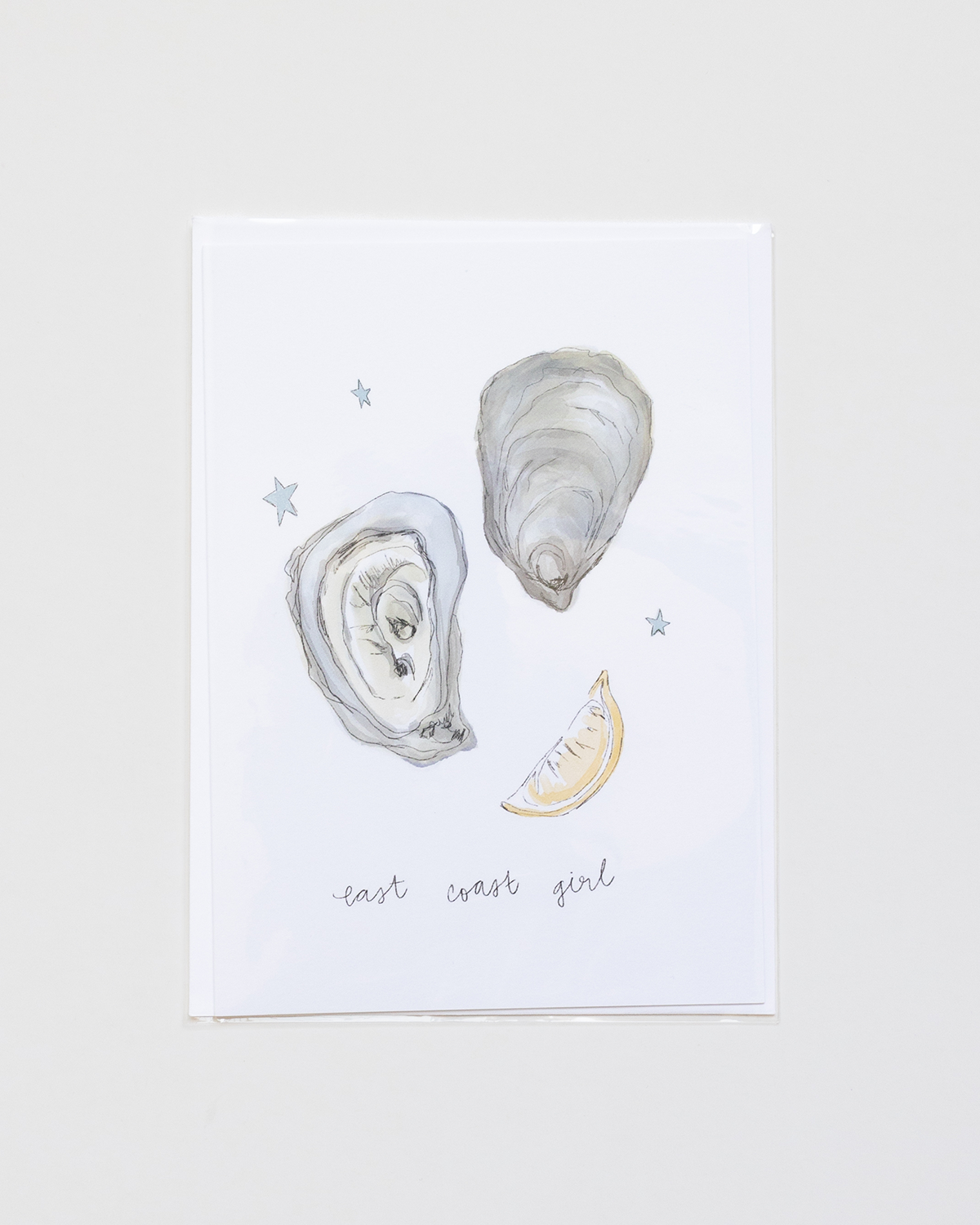Illustration of oyster shells and a lemon wedge on a light background with 'east coast girl' text.