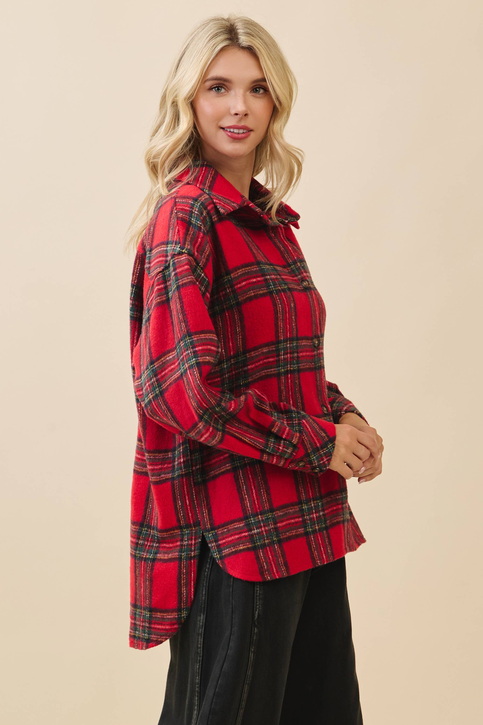 Woman wearing a red plaid shirt against a beige background