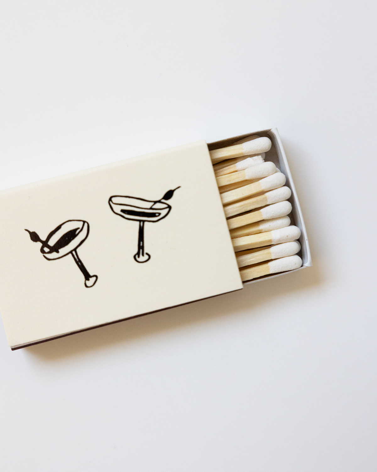 Matchbox with matches and cocktail illustrations on a white background