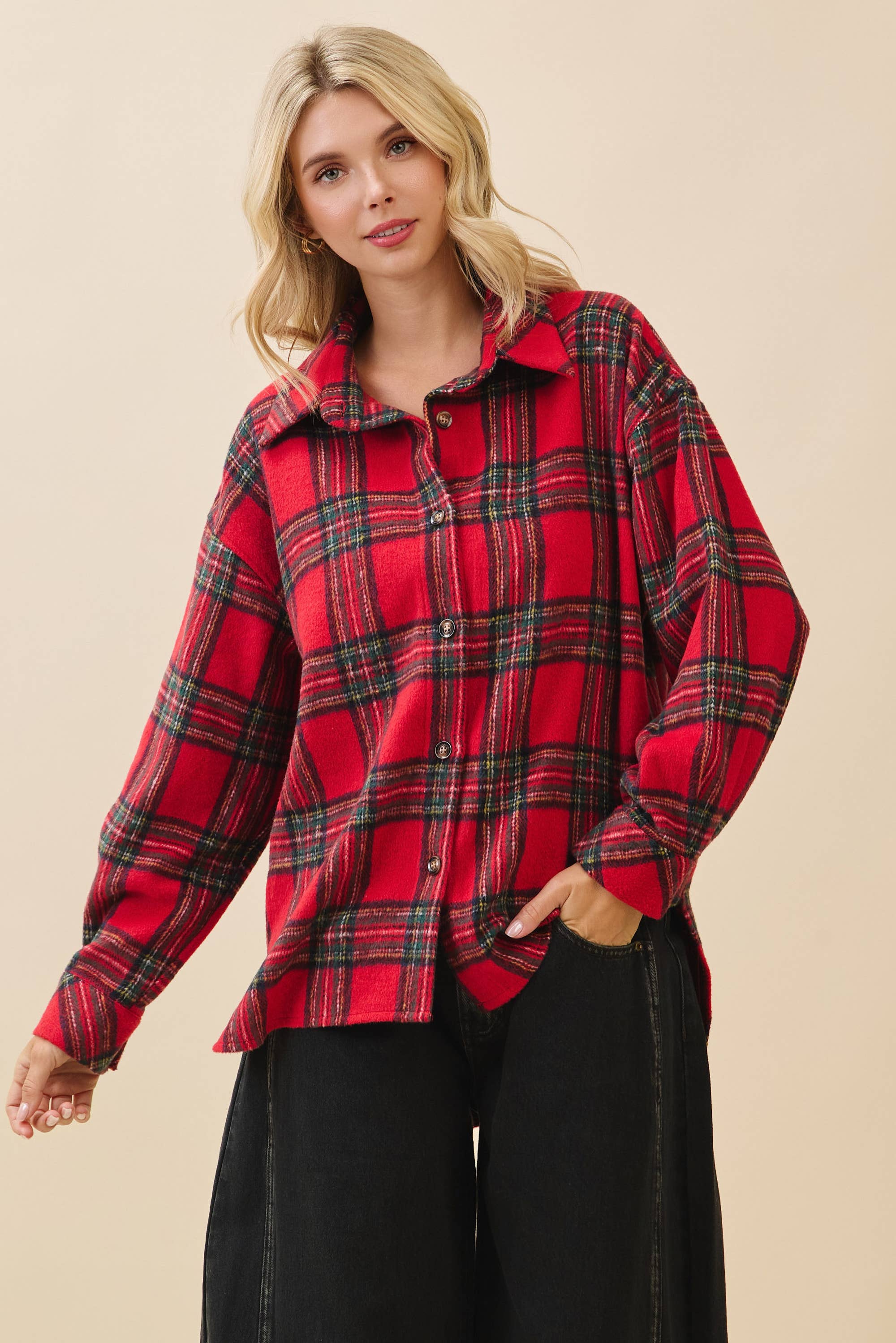 Woman wearing a red plaid shirt against a beige background