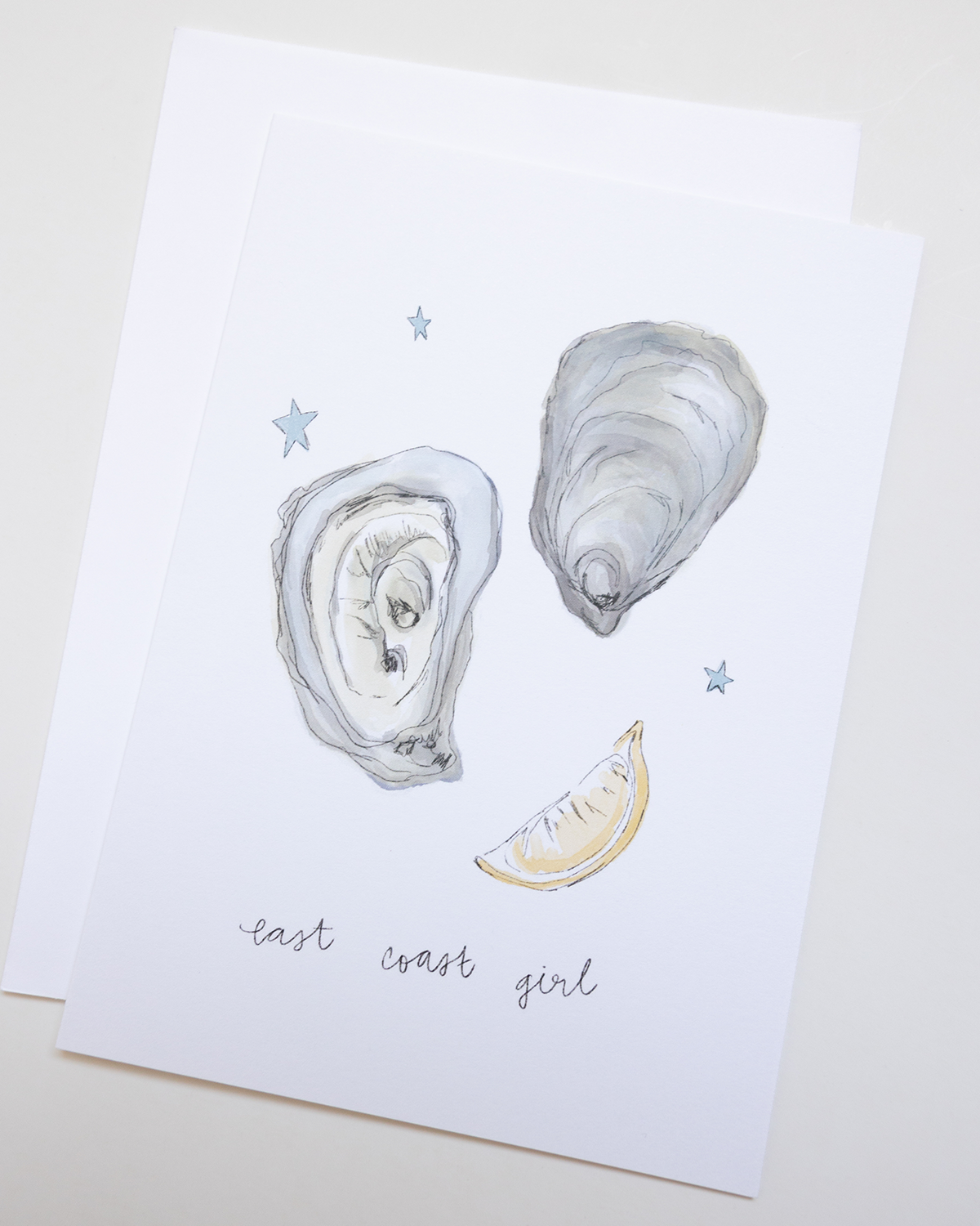 Illustration of oyster shells and a lemon wedge on a white background with 'east coast girl' text.