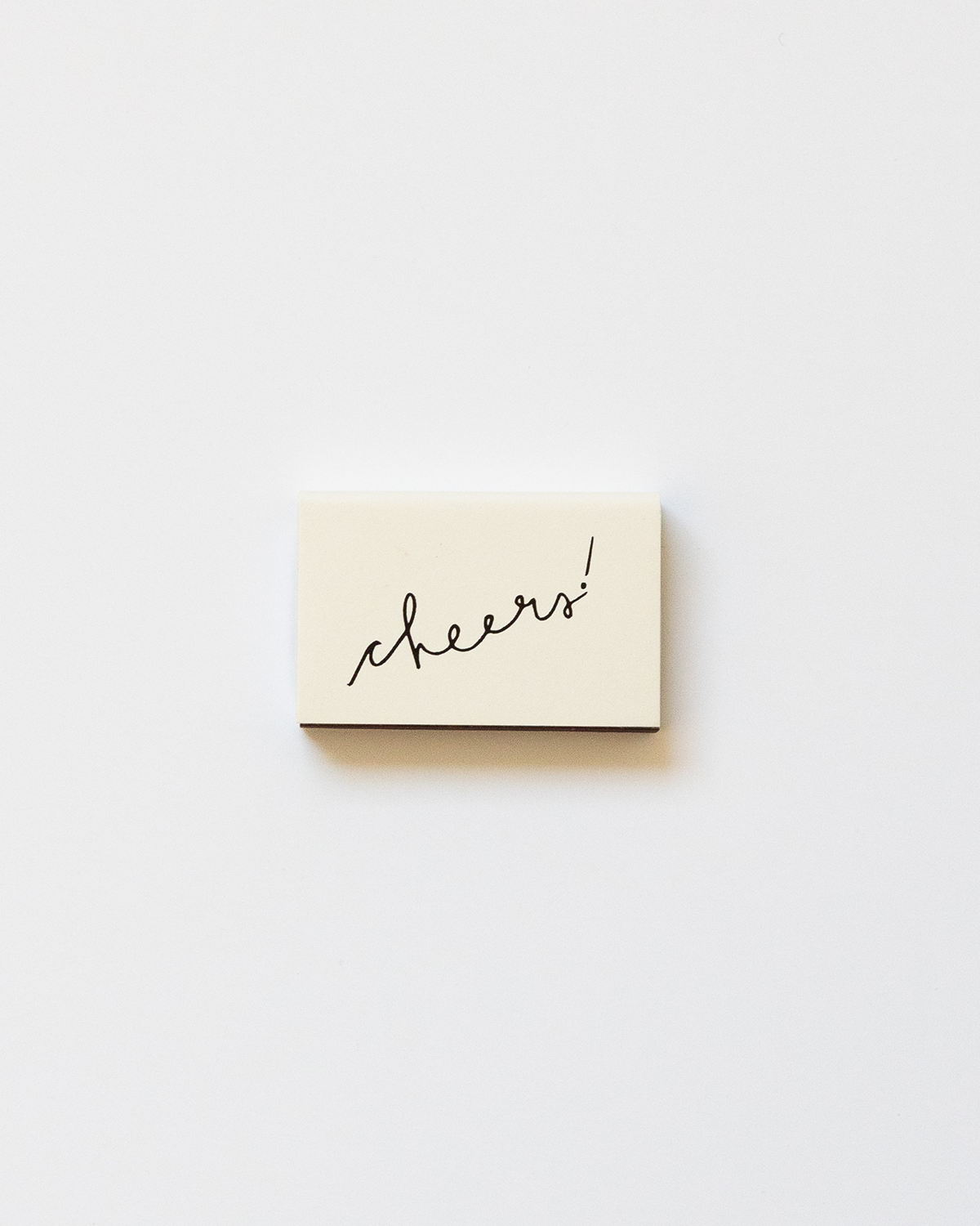 Small beige box with 'cheers!' text on a white background
