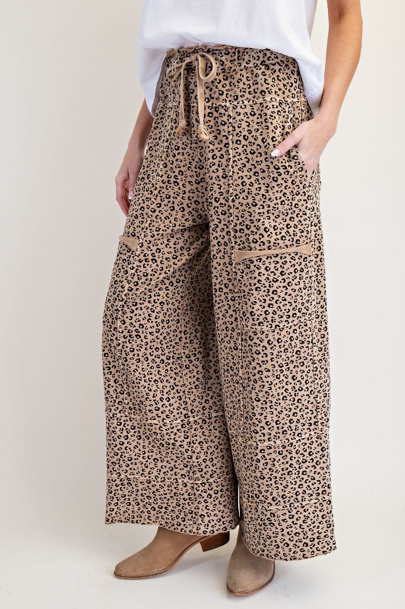 Leopard print wide-leg pants worn by a person on a plain background