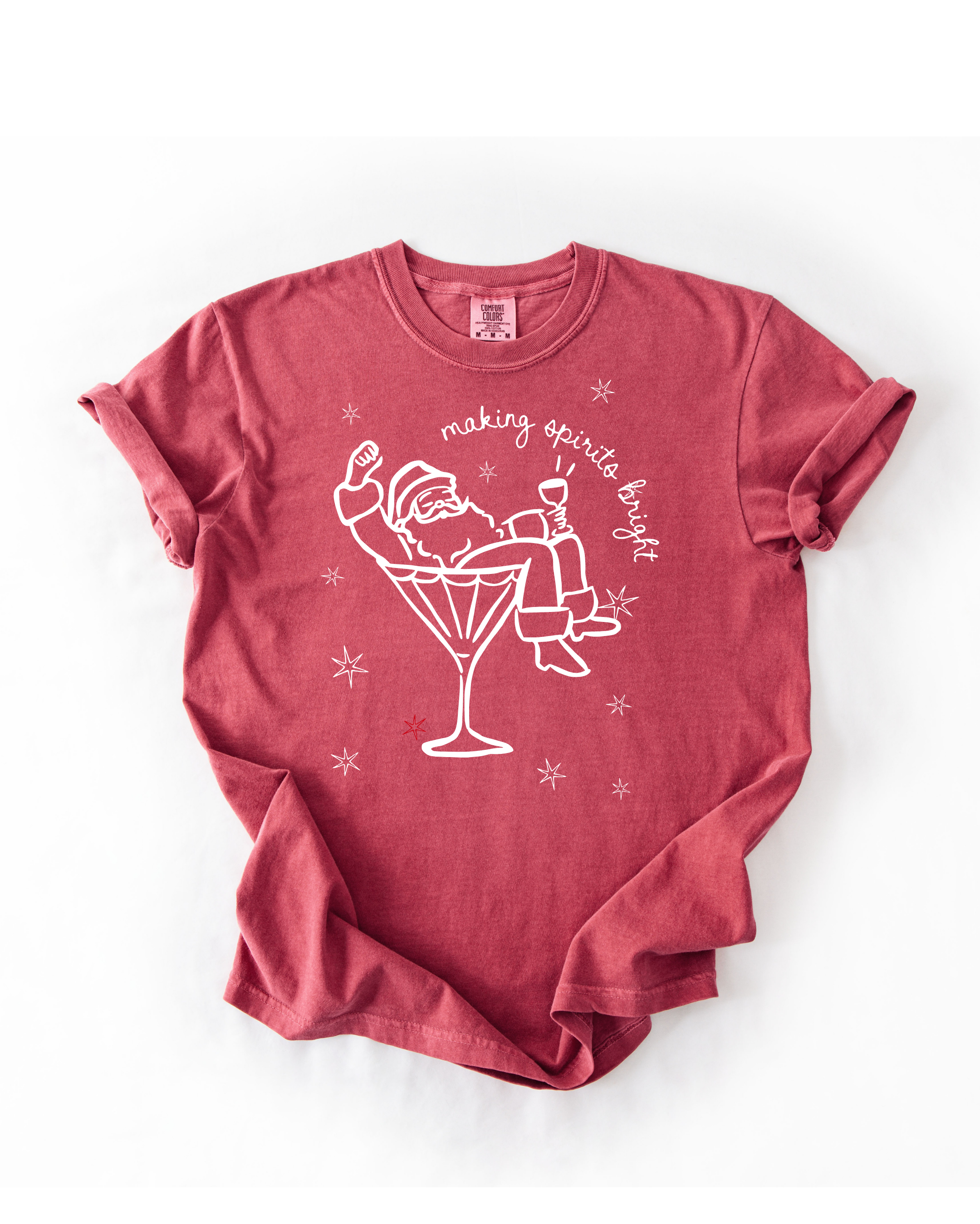 Red t-shirt with a graphic of Santa Claus in a martini glass and text 'making spirits bright' on a white background.