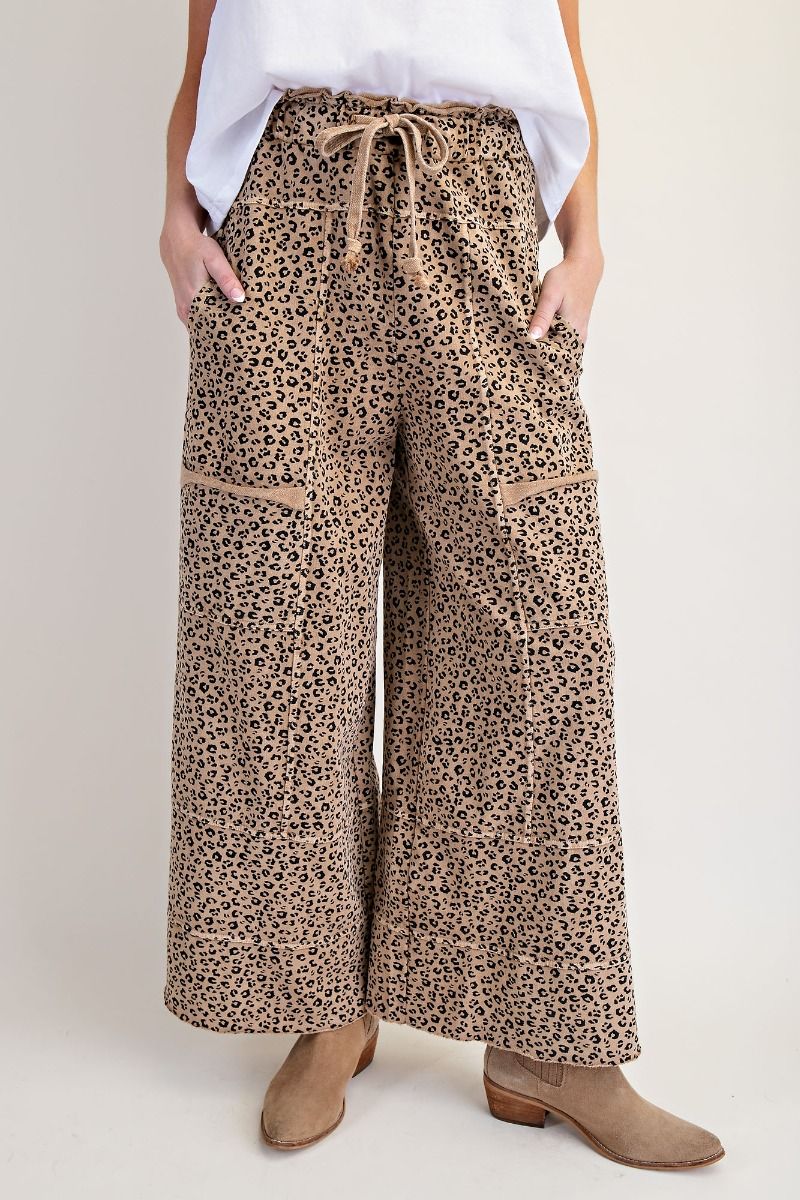 Leopard print wide-leg pants worn by a person on a plain background