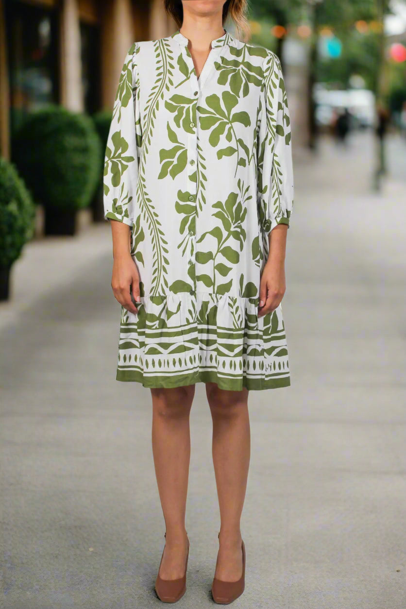 Green and white patterned dress on a white background