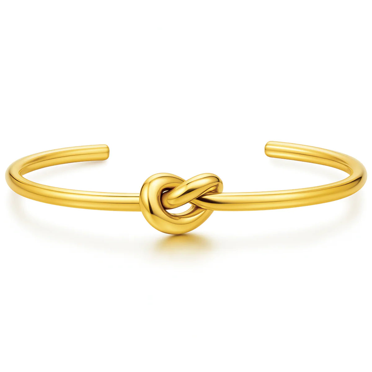 Gold knot bracelet on a white background