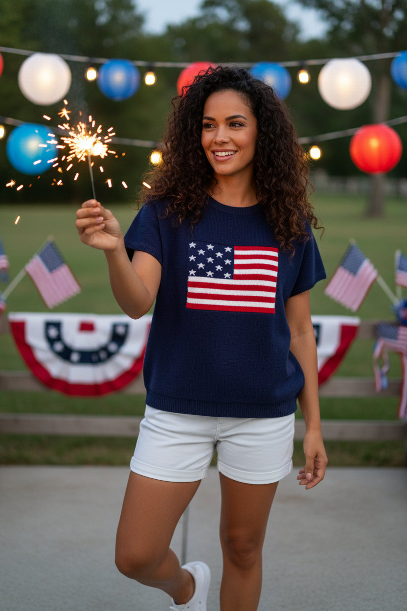 Woman wearing a navy blue t-shirt with an American flag design on a white background