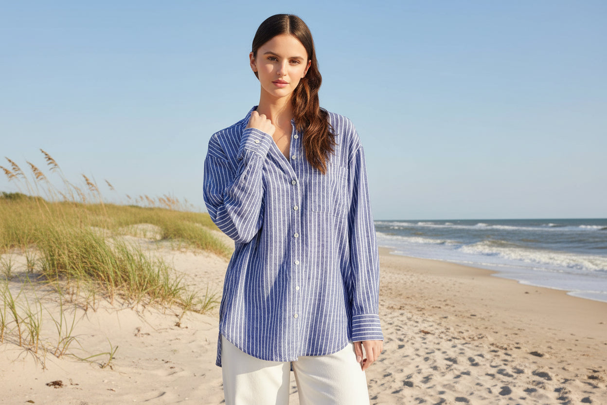 Woman wearing a blue and white striped shirt against a plain background