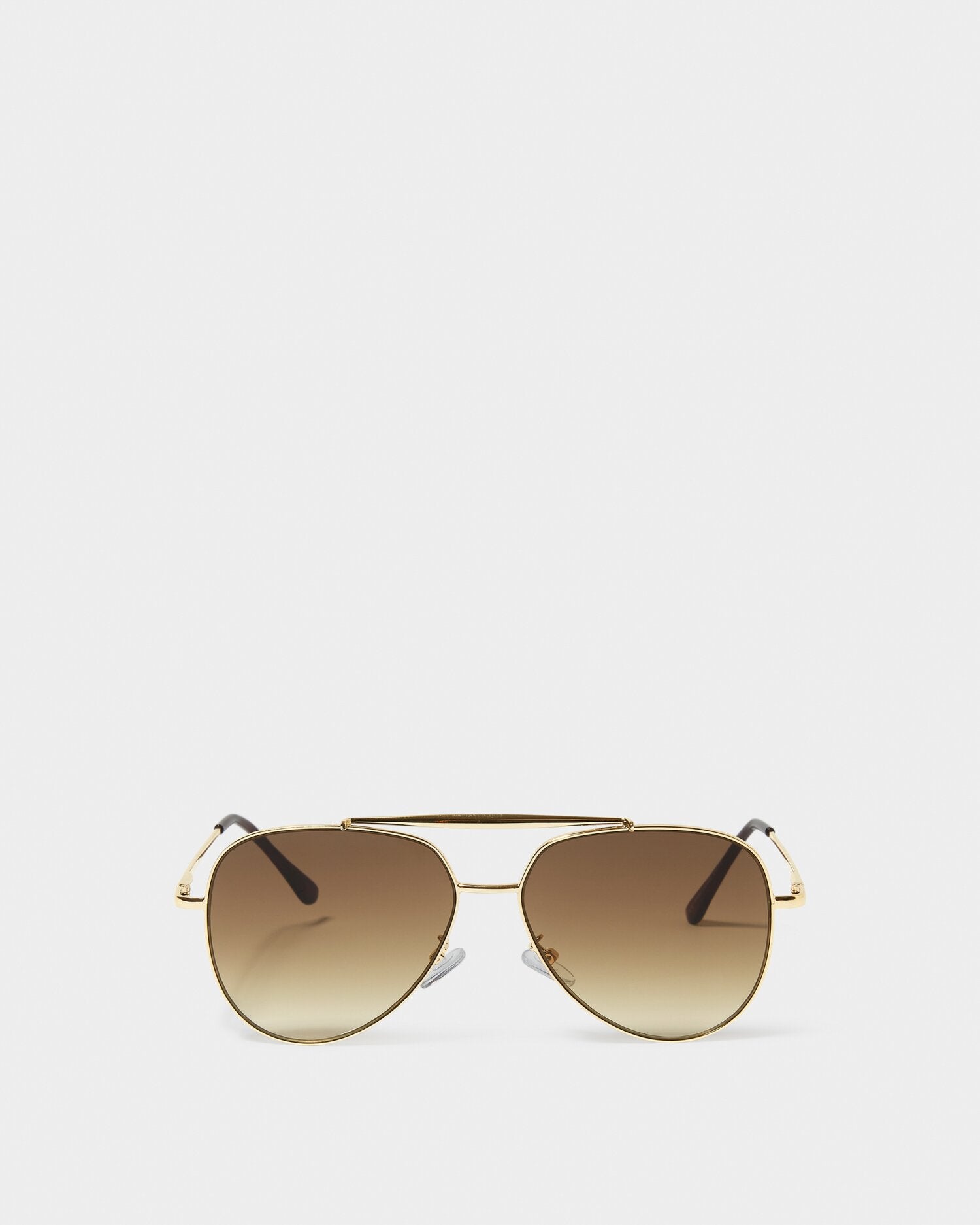 Gold aviator sunglasses with brown gradient lenses on a white background