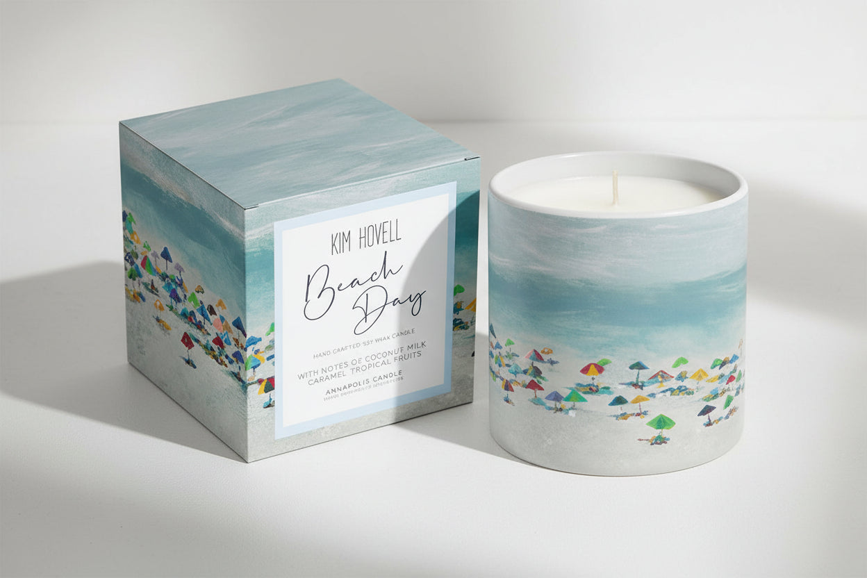 Candle with beach-themed design and packaging on a white background