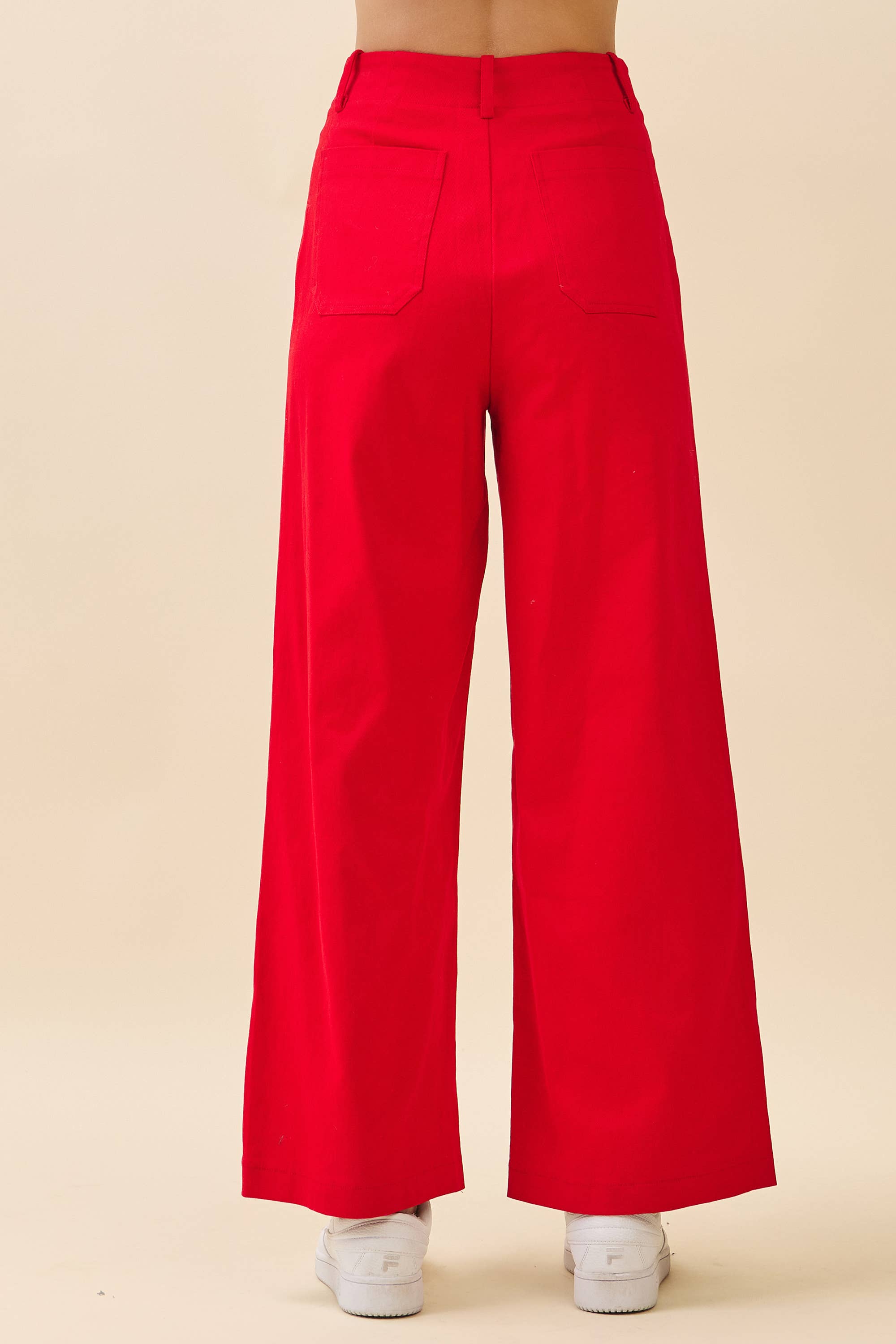 Red wide-leg pants on a beige background