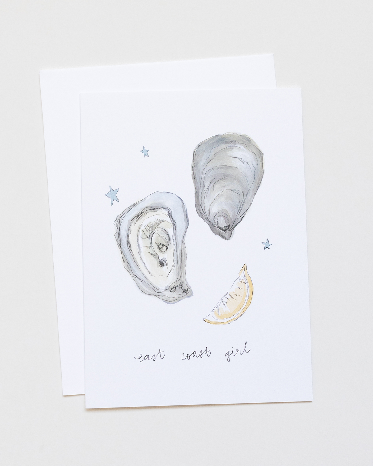 Card with illustrations of seashells and a lemon wedge on a white background with 'east coast girl' text.