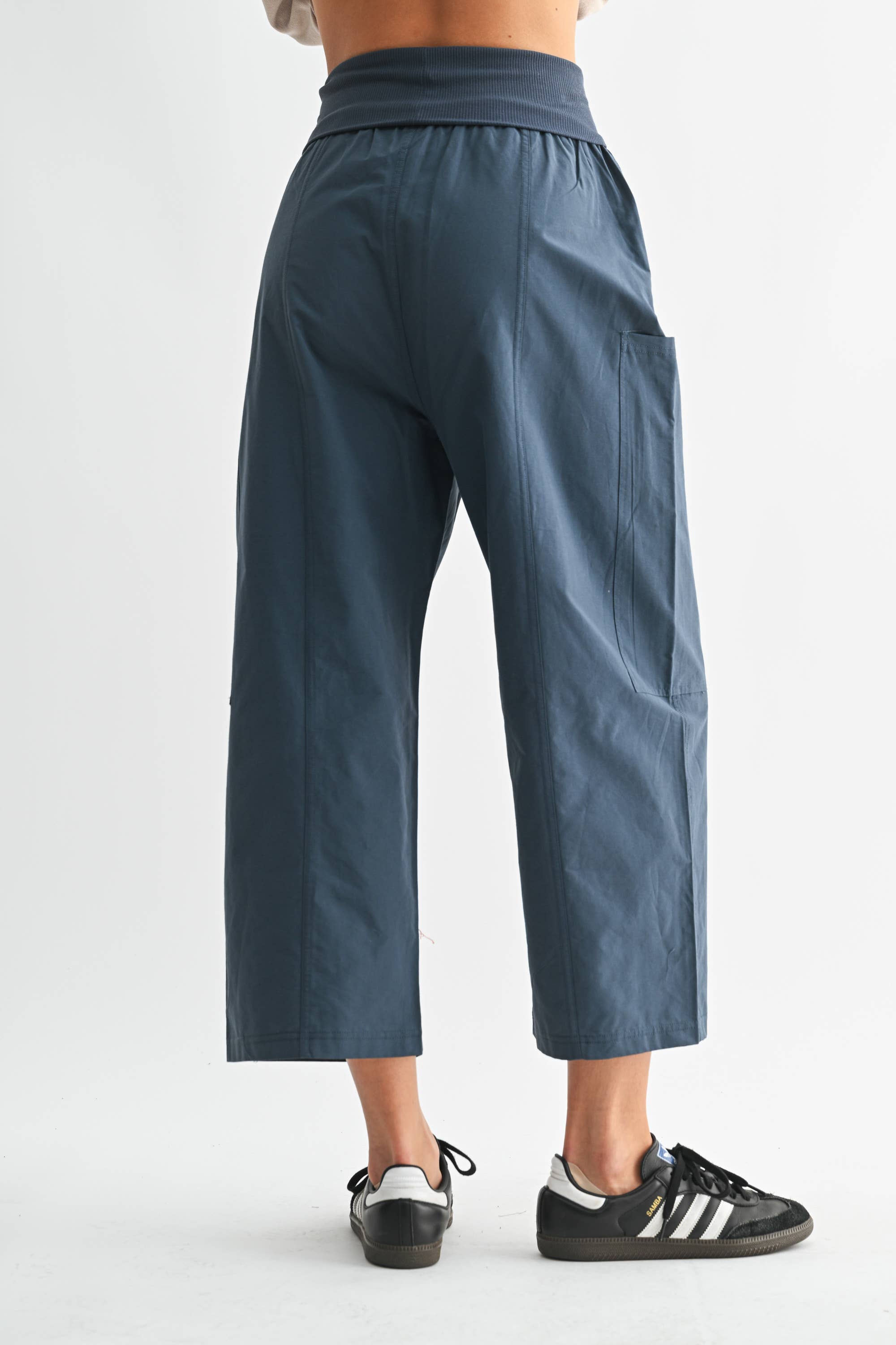 Person wearing blue pants on a white background