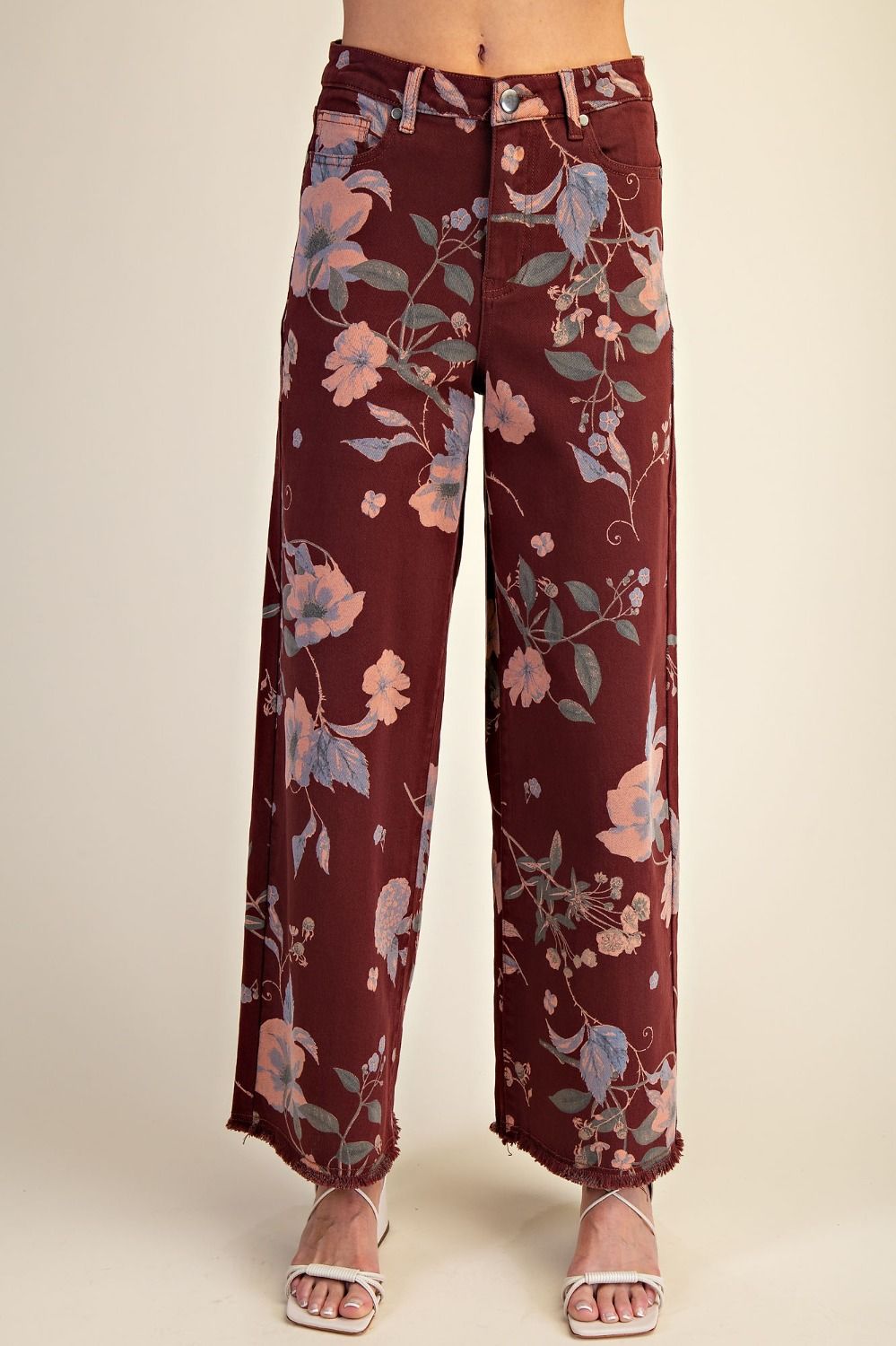 Maroon floral pants on a plain background