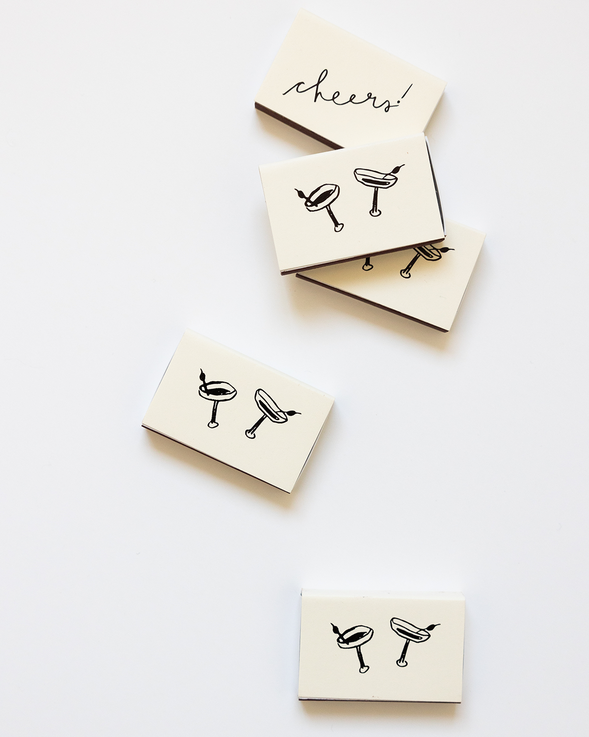 Set of four coasters with drink illustrations and 'cheers!' text on a white background