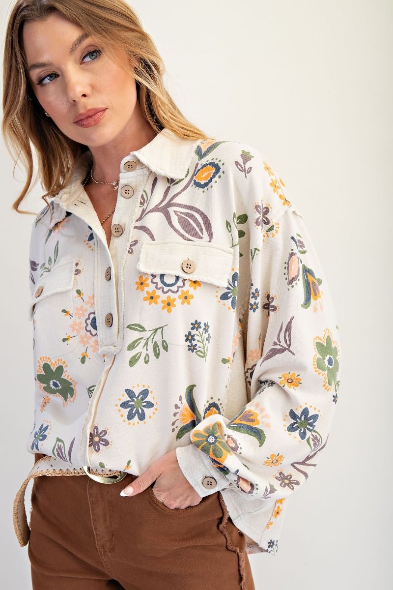 Woman wearing a floral patterned jacket against a white background