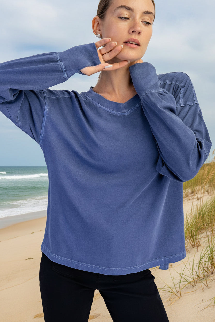 Woman wearing a blue oversized sweatshirt against a white background
