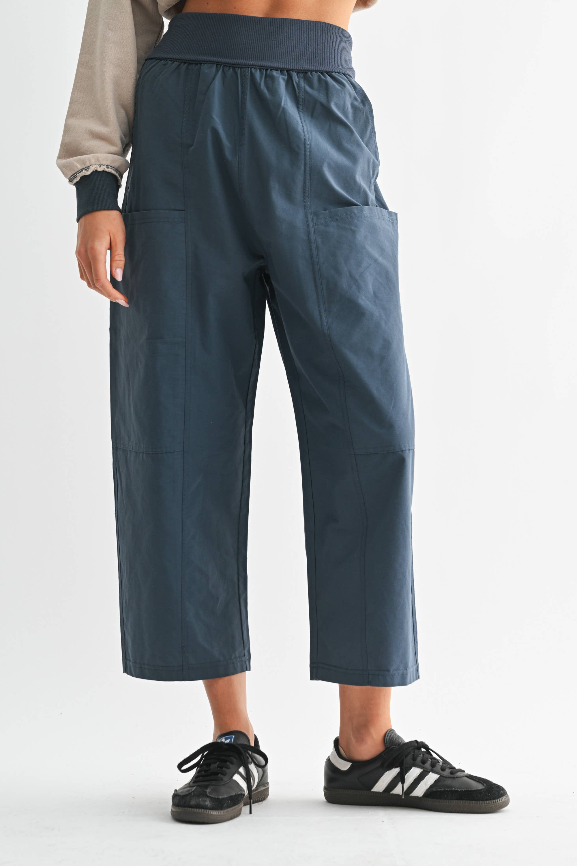 Person wearing teal pants on a white background